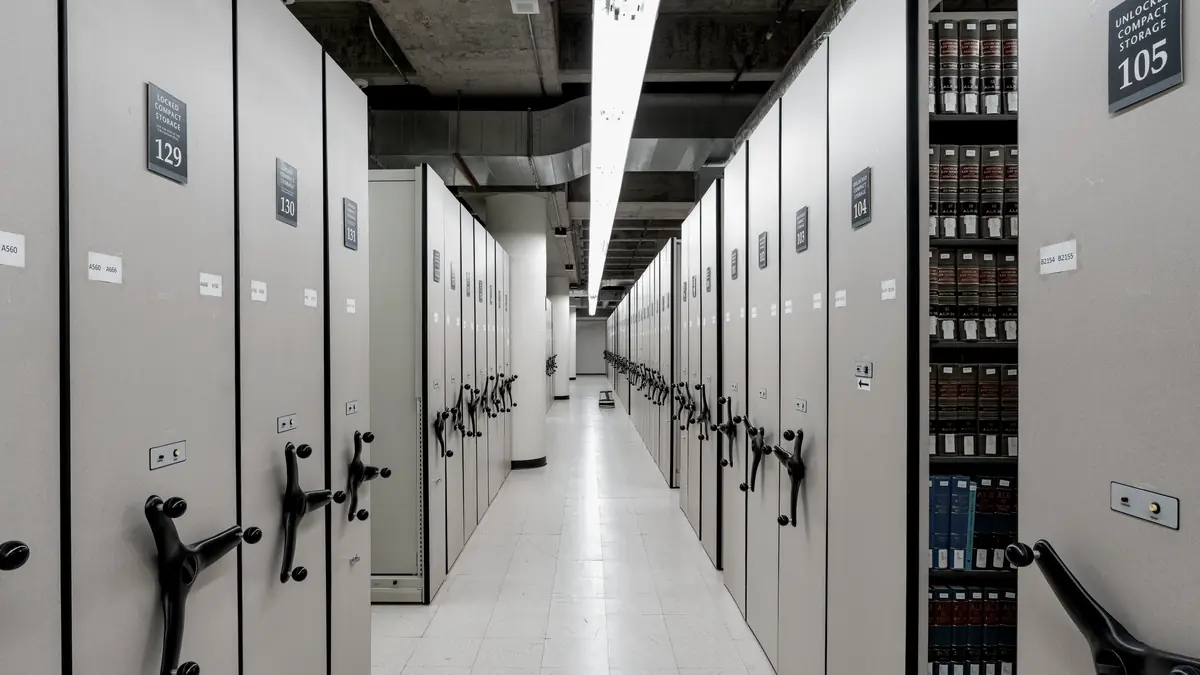 A corridor of compact rolling shelving in a records archive