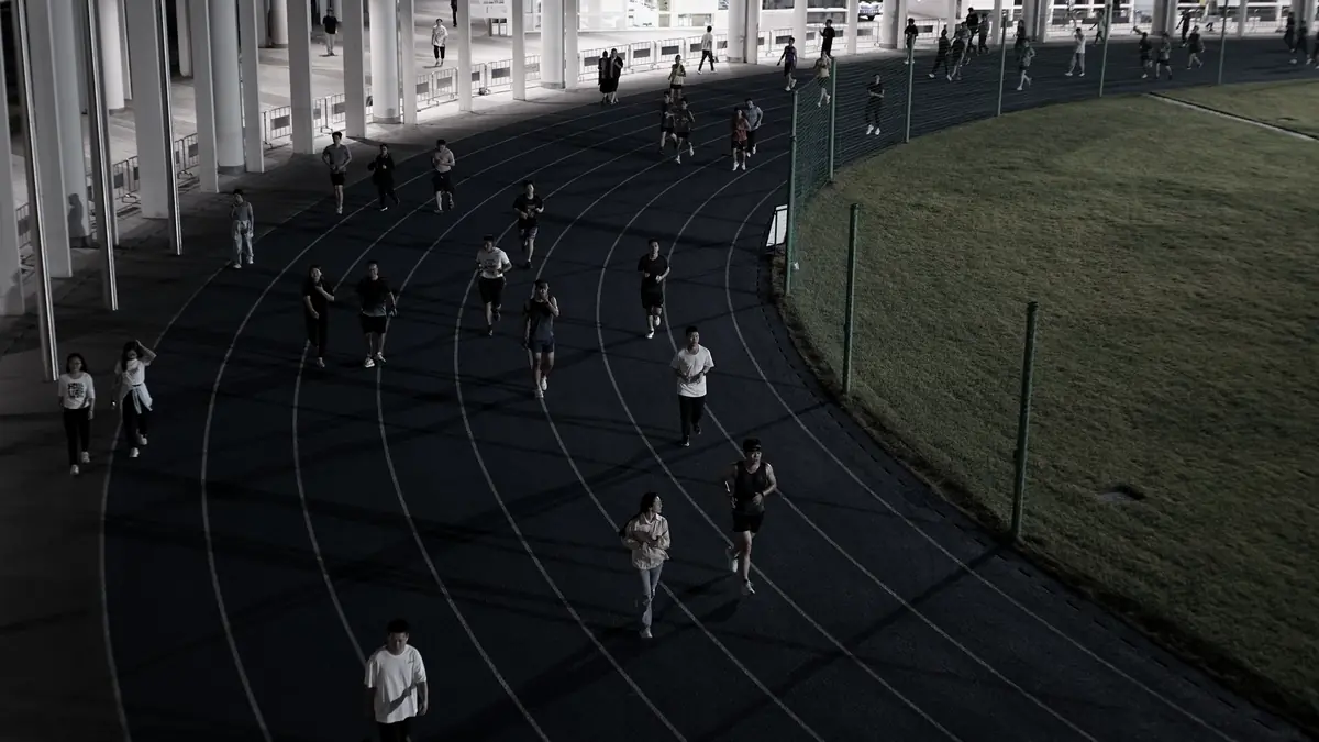 Runners spread across the lanes of an athletics track, seen from above